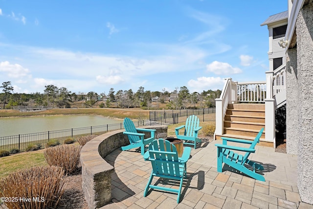 740 Waterstone Dr, Wilmington, NC 28411 - view of patio / terrace with an outdoor fire pit, a water view, and stairway
