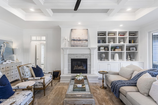 living area featuring coffered ceiling, crown molding, and beam ceiling