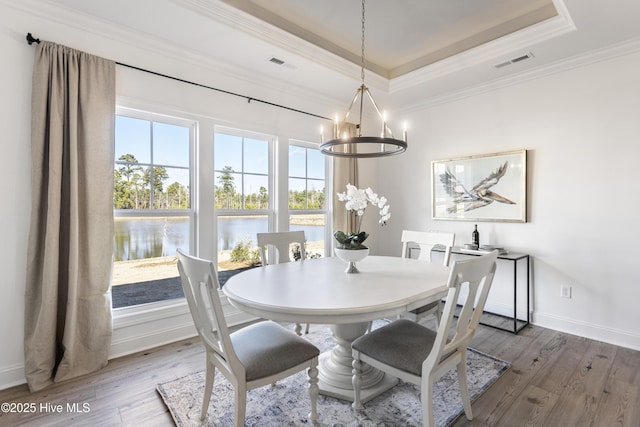 dining area featuring a chandelier, light wood-type flooring, and visible vents