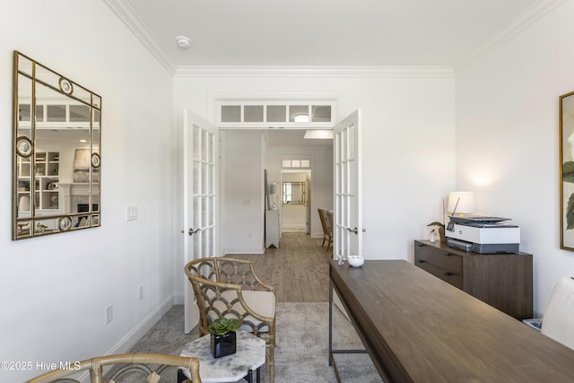 office area with french doors, crown molding, and wood finished floors