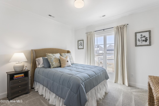 carpeted bedroom featuring baseboards, ornamental molding, and visible vents