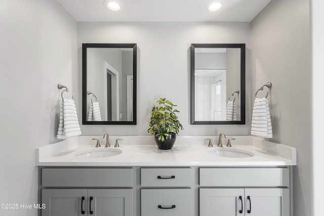 full bathroom featuring a sink, double vanity, and recessed lighting