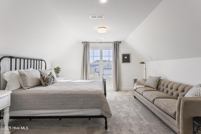 bedroom featuring baseboards, light carpet, visible vents, and vaulted ceiling