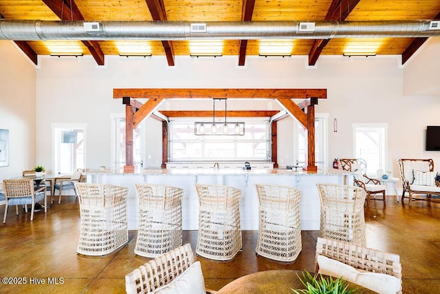 dining room featuring wooden ceiling, a wealth of natural light, and beamed ceiling