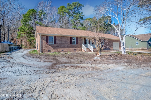 single story home featuring a garage and a porch