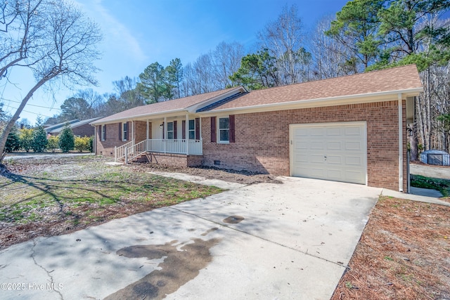 ranch-style house featuring a garage and covered porch