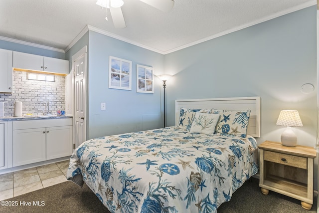 bedroom with sink, ornamental molding, and a textured ceiling