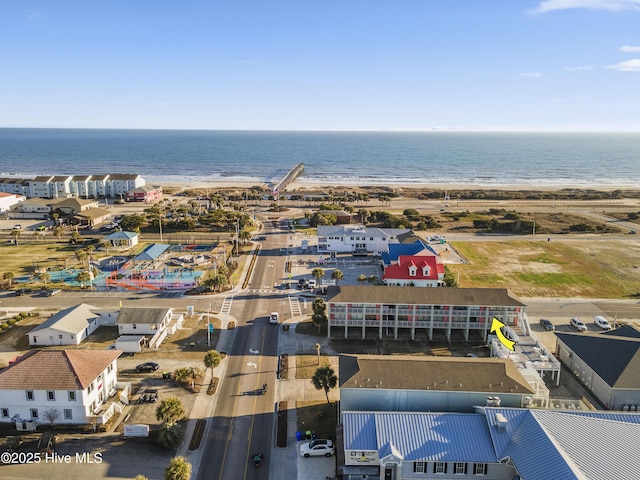 drone / aerial view featuring a water view and a beach view