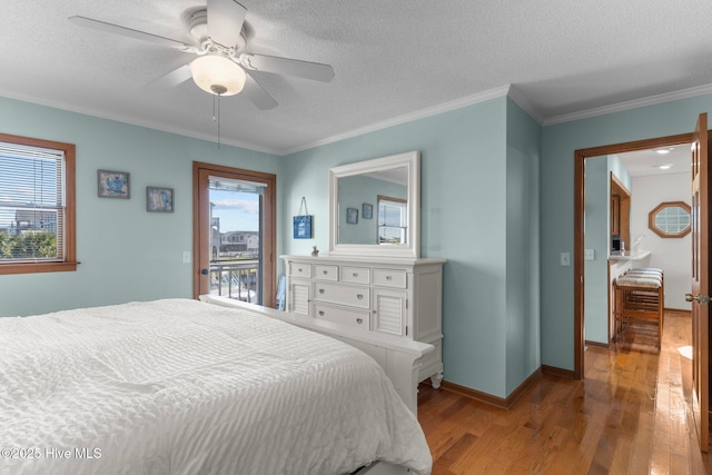 bedroom with ornamental molding, access to outside, multiple windows, and wood finished floors