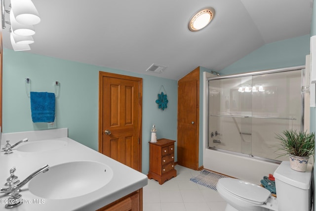 bathroom featuring toilet, bath / shower combo with glass door, a sink, and visible vents