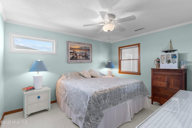 bedroom with crown molding, visible vents, a textured ceiling, and light colored carpet