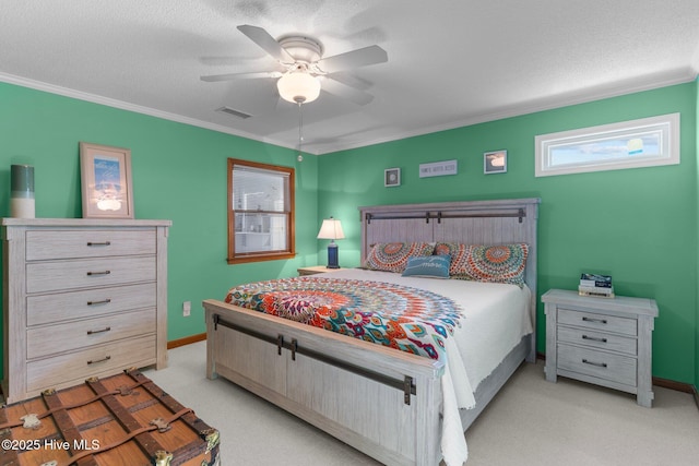 bedroom with ornamental molding, visible vents, light carpet, and a textured ceiling