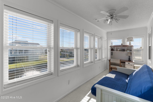 sunroom / solarium with a ceiling fan