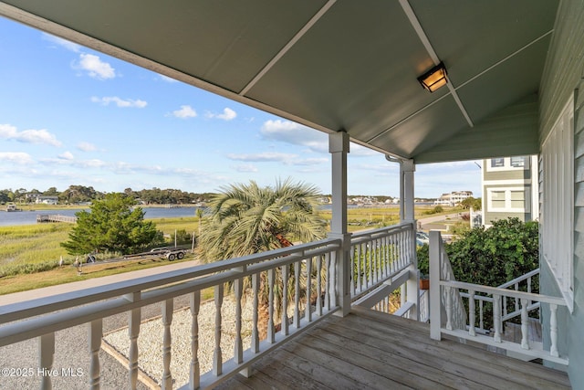 wooden deck featuring a water view