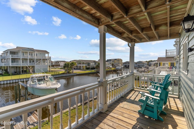 deck with a water view and a residential view