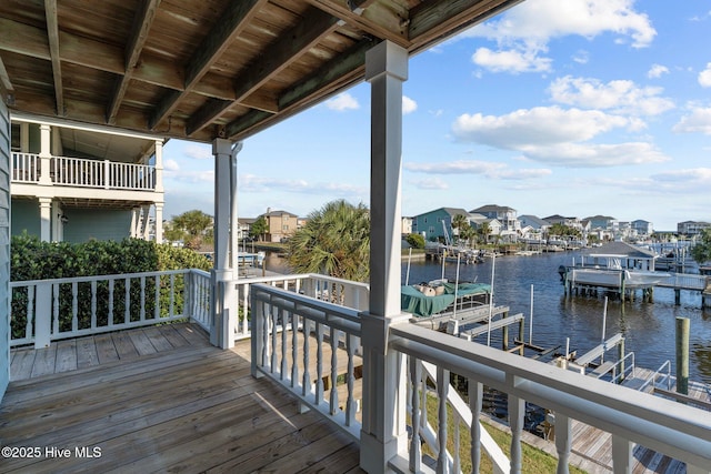 deck featuring a dock, a water view, and a residential view