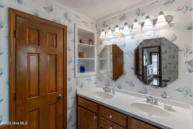 bathroom featuring a sink, a textured ceiling, and wallpapered walls