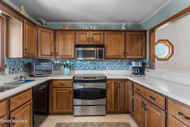 kitchen featuring stainless steel appliances, light countertops, brown cabinetry, and light tile patterned floors