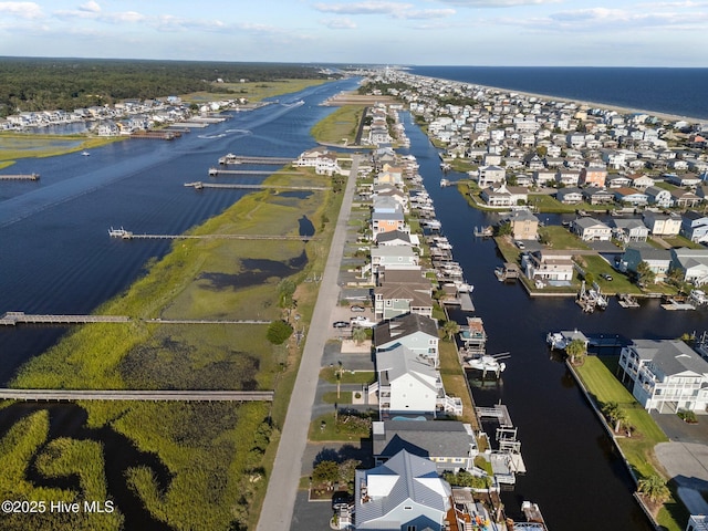 birds eye view of property with a water view and a residential view