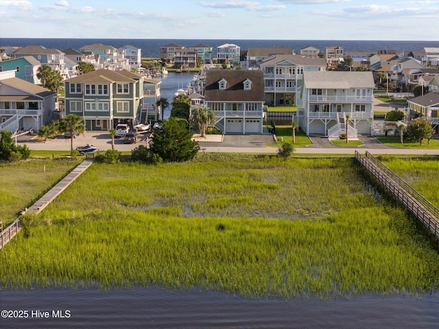 drone / aerial view featuring a water view and a residential view