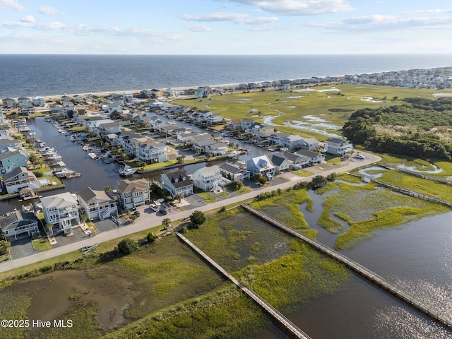 drone / aerial view featuring a water view and a residential view