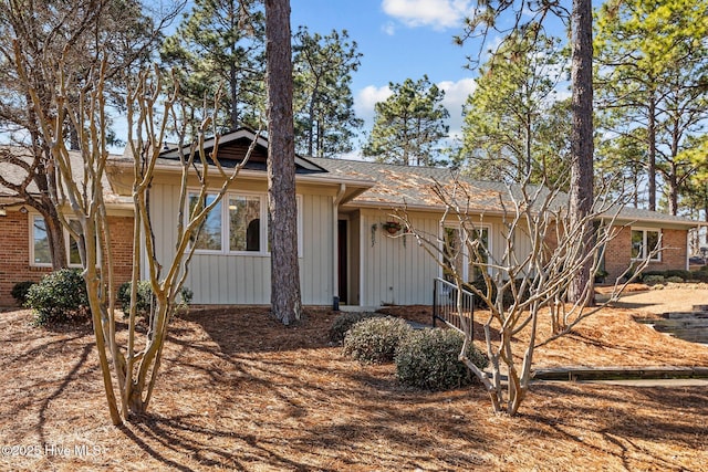 ranch-style house featuring brick siding