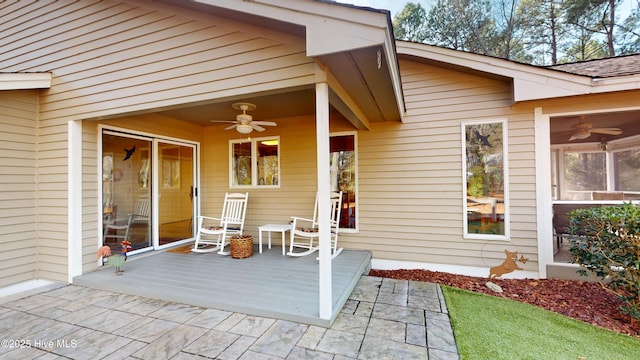 view of exterior entry featuring ceiling fan and a patio area