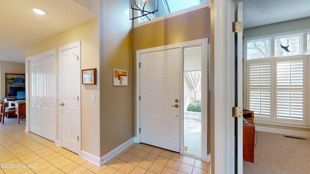 tiled foyer featuring a healthy amount of sunlight