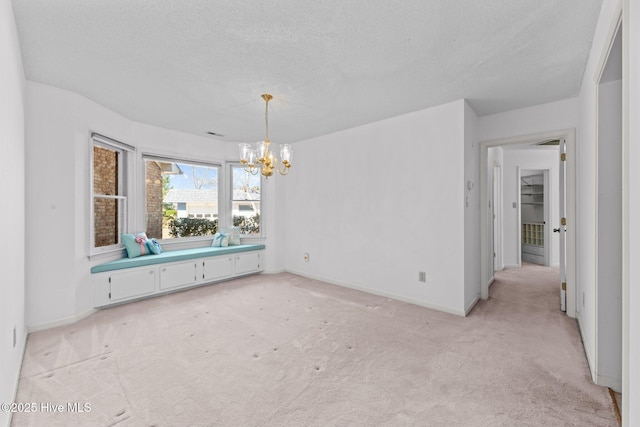 unfurnished dining area featuring light colored carpet, a notable chandelier, and a textured ceiling