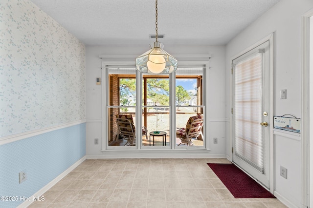 unfurnished dining area with a textured ceiling