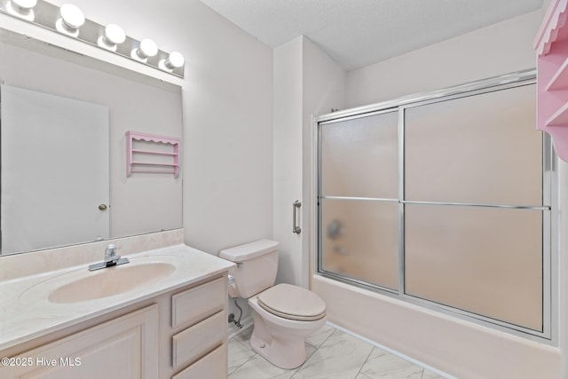 full bathroom with vanity, combined bath / shower with glass door, a textured ceiling, and toilet