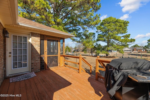 wooden deck featuring a grill