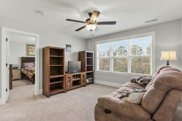 carpeted living room featuring ceiling fan