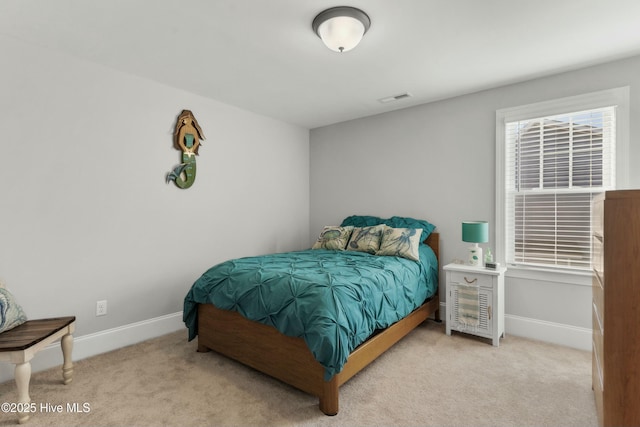 bedroom featuring light colored carpet