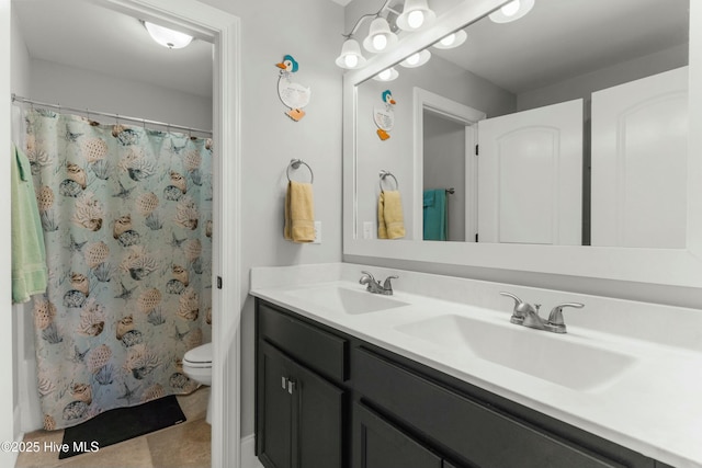 bathroom with vanity, tile patterned flooring, and toilet