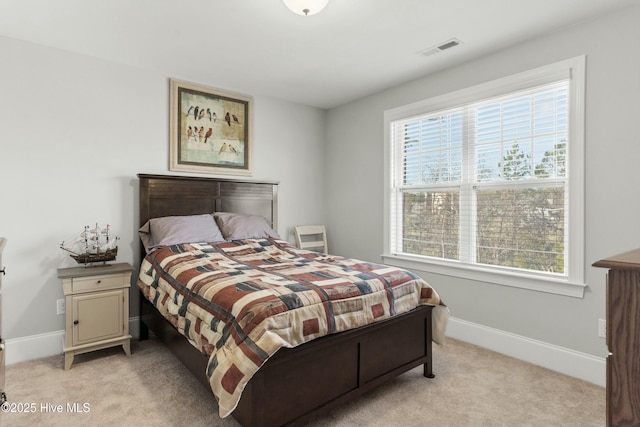 carpeted bedroom featuring multiple windows