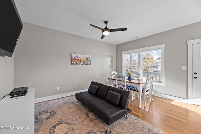 living room featuring hardwood / wood-style flooring and ceiling fan