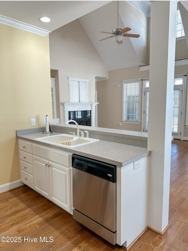 kitchen featuring white cabinetry, dishwasher, sink, and light wood-type flooring