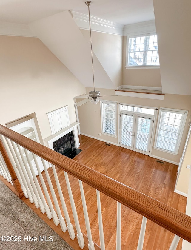 staircase featuring hardwood / wood-style flooring, high vaulted ceiling, french doors, and ceiling fan