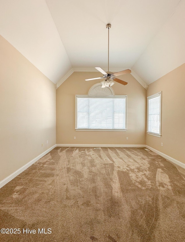 spare room featuring ceiling fan, lofted ceiling, and carpet