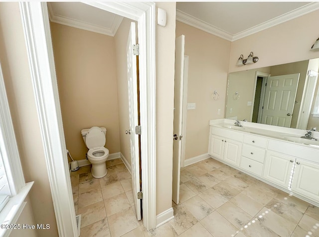 bathroom featuring crown molding, vanity, and toilet