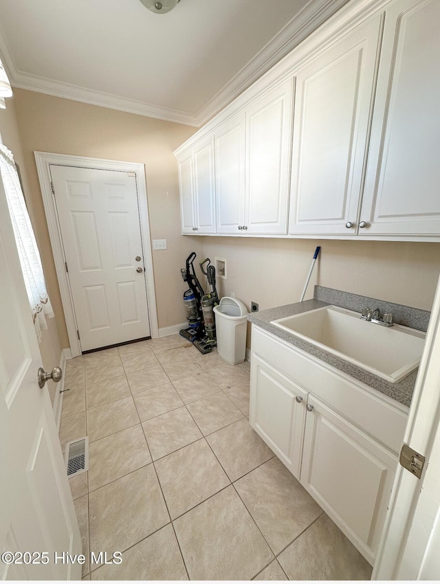 laundry area with sink, crown molding, light tile patterned floors, hookup for a washing machine, and cabinets