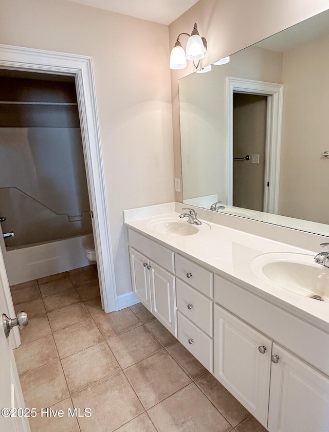 bathroom featuring vanity, tile patterned floors, and toilet