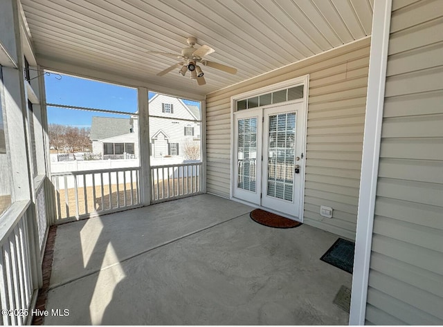 unfurnished sunroom with wooden ceiling and ceiling fan