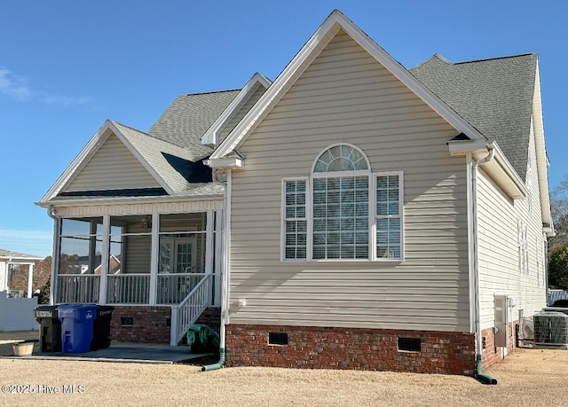 back of property featuring cooling unit and a sunroom