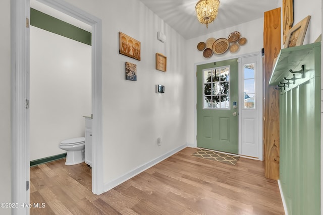 entryway with a chandelier and light hardwood / wood-style floors