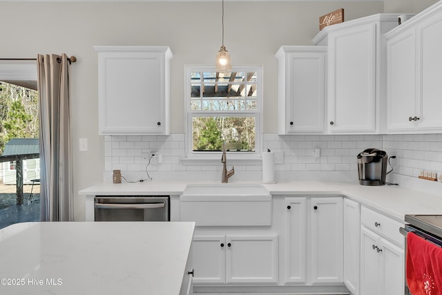 kitchen with sink, decorative light fixtures, stainless steel dishwasher, white cabinets, and backsplash