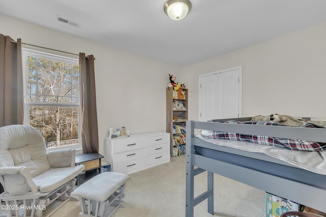 carpeted bedroom featuring multiple windows