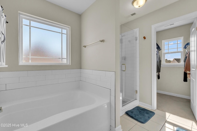 bathroom featuring tile patterned floors and independent shower and bath