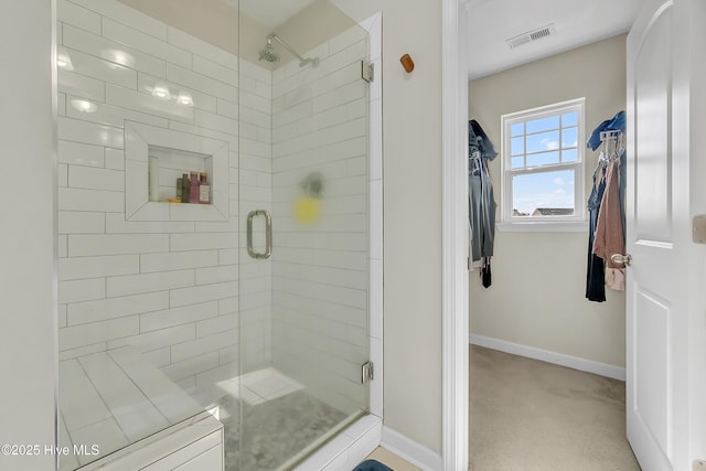 bathroom with a shower with door